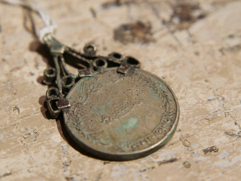 antique pendage with silver alloy coin