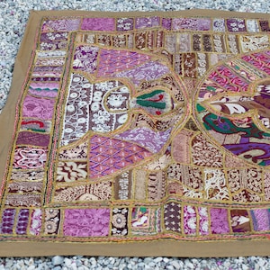 May include: A large, colorful patchwork quilt with a variety of fabrics and textures. The quilt is made up of many different pieces of fabric, sewn together in a random pattern. The quilt is decorated with gold embroidery and sequins.