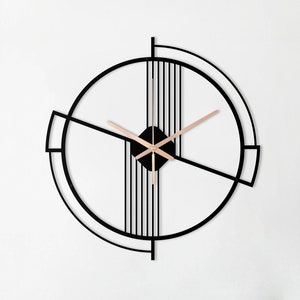 May include: A black metal wall clock with a geometric design. The clock has a circular shape with a thin black frame and a gold-colored center. The clock hands are also gold-colored.