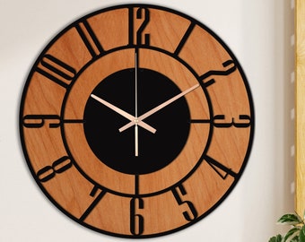 May include: A large, round wooden wall clock with black Roman numeral markings and black hands. The clock face is surrounded by a black ring and has a black background.
