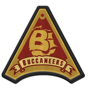 May include: A triangular patch with a black border and a gold background. The patch features a gold ship with a large "B" on the sail and the text "BUCCANEERS" in a gold banner.