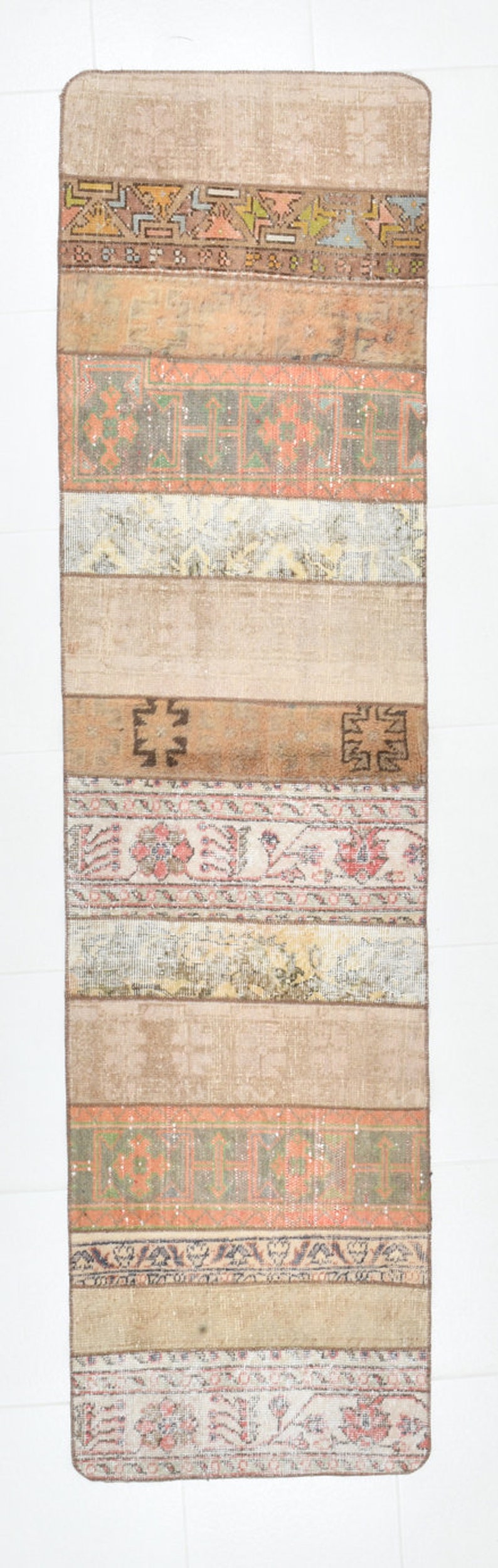 May include: A vintage Turkish kilim rug with a beige background and colorful geometric patterns. The rug is made of wool and has a hand-woven texture.