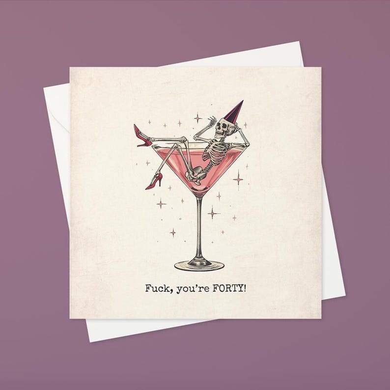 May include: Greeting card with a humorous illustration of a skeleton relaxing in a pink martini glass, wearing a party hat and red high heels. The text "Fuck, you're FORTY!" is printed below the image.