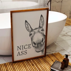 White and grey bathroom wall art print featuring a donkeys face with the humourous quote Nice Ass.