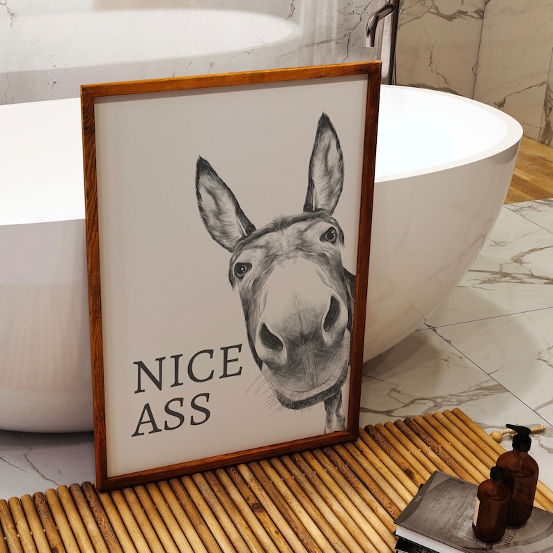 White and grey bathroom wall art print featuring a donkeys face with the humourous quote Nice Ass.