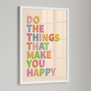 May include: A white framed print with a peach background and colorful text that reads "Do the things that make you happy".