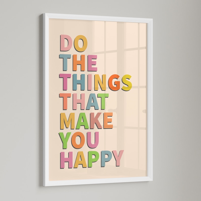 May include: A white framed print with a peach background and colorful text that reads "Do the things that make you happy".