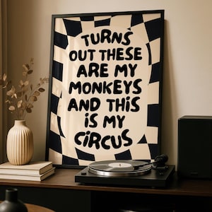 May include: A rectangular framed wall art print featuring a black and cream checkered pattern background. The centre contains the black text: TURNS OUT THESE ARE MY MONKEYS AND THIS IS MY CIRCUS, written in a bold, rounded, and playful typeface.