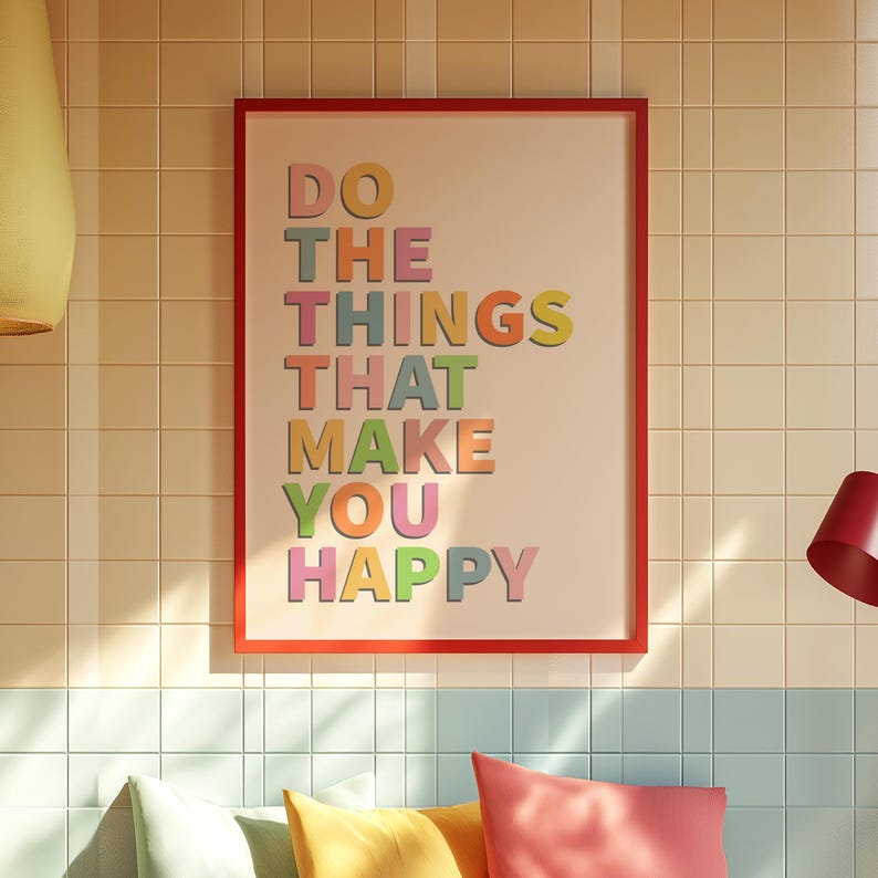 May include: A framed print with the text "DO THE THINGS THAT MAKE YOU HAPPY" in colorful letters on a light pink background.