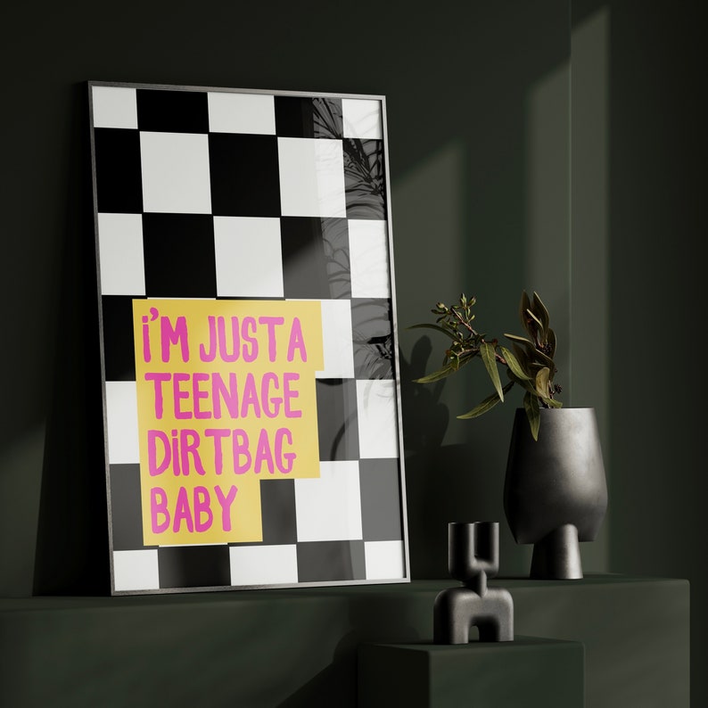 May include: A black and white checkered poster with a yellow sticky note that says "i'm just a teenage dirtbag baby" in pink lettering.