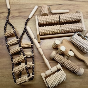 Può includere: Un set di rulli da massaggio in legno di diverse forme e dimensioni. I rulli hanno punte per l'agopressione e sono progettati per l'automassaggio.