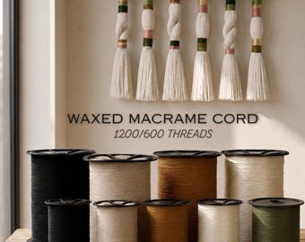 May include: Six spools of waxed macrame cord in black, beige, brown, and olive green, arranged in two rows. Above, six decorative tassels hang from a wooden rod, featuring wrapped sections in pink, green, and gold. Text reads: WAXED MACRAME CORD 1200/600 THREADS.