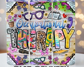 May include: A colorful tumbler with the words "Occupational Therapy" in a playful font. The design includes eyeglasses, flowers, a phone, and a notebook against a wood-grain background. The words "Fast Delivery" are at the bottom.