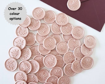 May include: A collection of over 30 rose gold wax seals with a leaf design.
