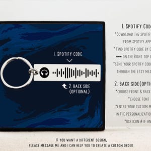 May include: A silver keychain with a black and white Spotify code on a blue background. The text "1. Spotify Code" and "2. Back Side (Optional)" is displayed on the image. Instructions for using the Spotify code are listed below the image.