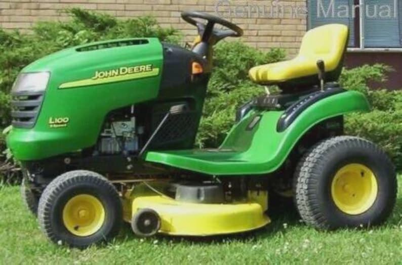 May include: A green and yellow John Deere L100 ride-on lawnmower. The mower features a black steering wheel, a yellow seat, and large black tyres with yellow rims. The John Deere logo is visible on the side of the mower.