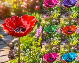 May include: A collection of colorful, flower-shaped bird baths. The bird baths are in shades of red, purple, green, orange, pink, and blue. Each bath is mounted on a gold-colored metal stake, perfect for a garden.