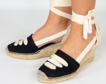 High-wedge espadrilles handmade with black fabric and ivory white ribbons.