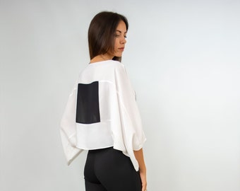 Minimalist style blouse with kimono sleeves and boat neck.