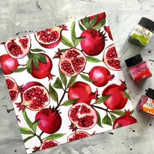 May include: A white background with a repeating pattern of red pomegranates and green leaves. The pomegranates are drawn in a watercolor style and some are cut open to show the seeds inside.