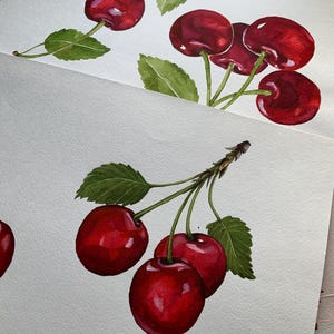 May include: Watercolor painting of red cherries with green leaves. The cherries are arranged in two clusters, one with four cherries and the other with three cherries.