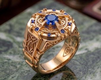 Anillo de hombre de oro macizo de 14 quilates con zafiro y detalles intrincados.