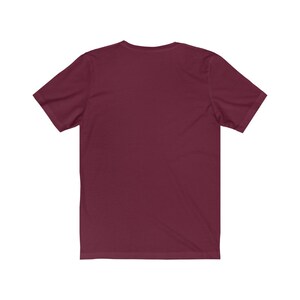 May include: A plain maroon short-sleeved t-shirt.