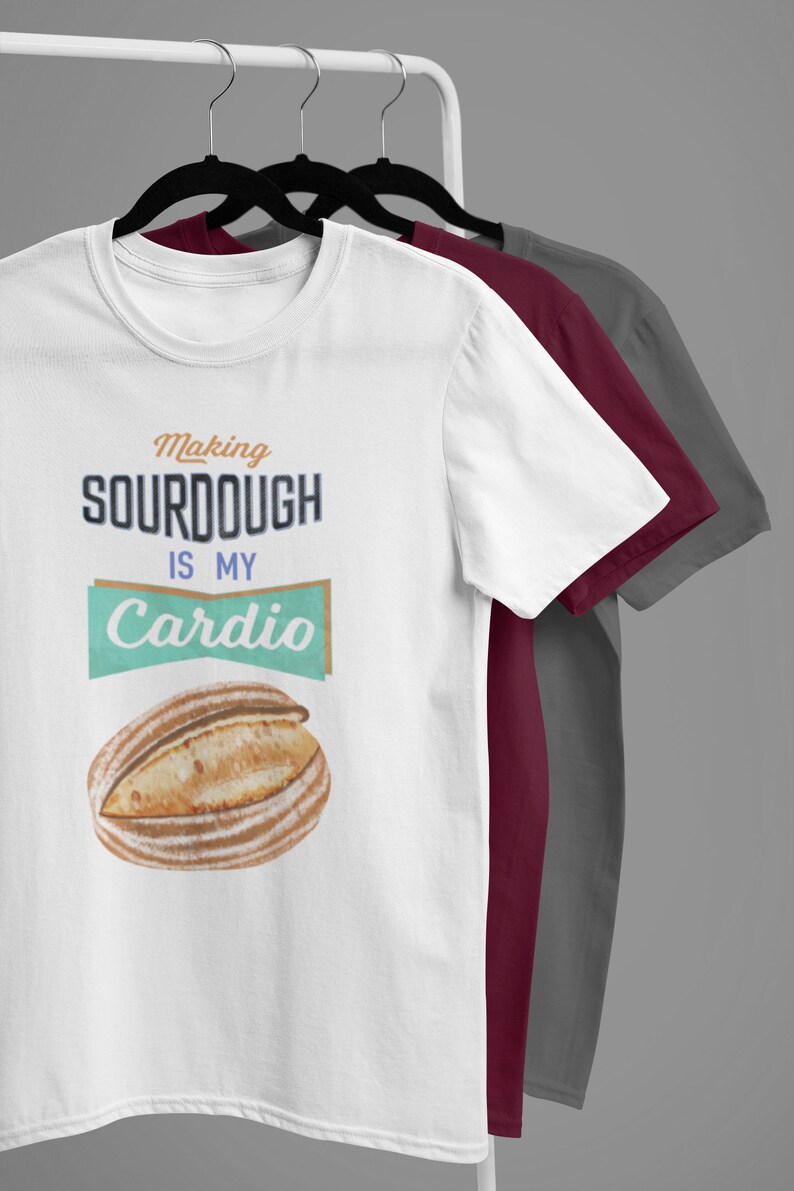 May include: White t-shirt with the text "Making sourdough is my cardio" and a graphic of a loaf of sourdough bread.