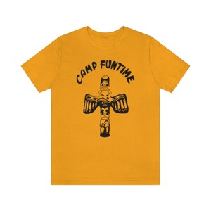 May include: A yellow t-shirt with a black graphic of a totem pole and the text "Camp Funtime".