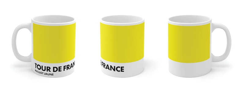 May include: White ceramic mug with a yellow band and black text that reads "TOUR DE FRANCE MAILLOT JAUNE".