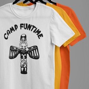 May include: Three white t-shirts with black text and a graphic of a totem pole with a face on top. The text on the shirt reads "Camp Funtime".