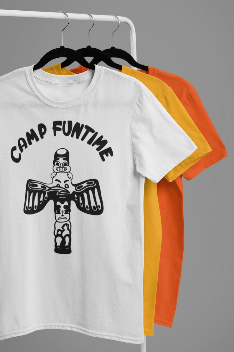 May include: Three white t-shirts with black text and a graphic of a totem pole with a face on top. The text on the shirt reads "Camp Funtime".