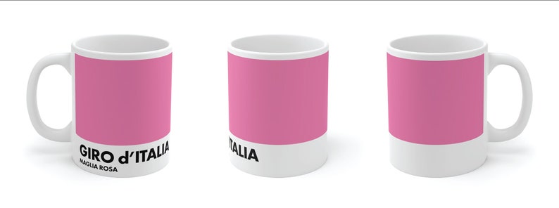 May include: A white ceramic mug with a pink stripe and the text "GIRO d'ITALIA MAGLIA ROSA" printed on the front.