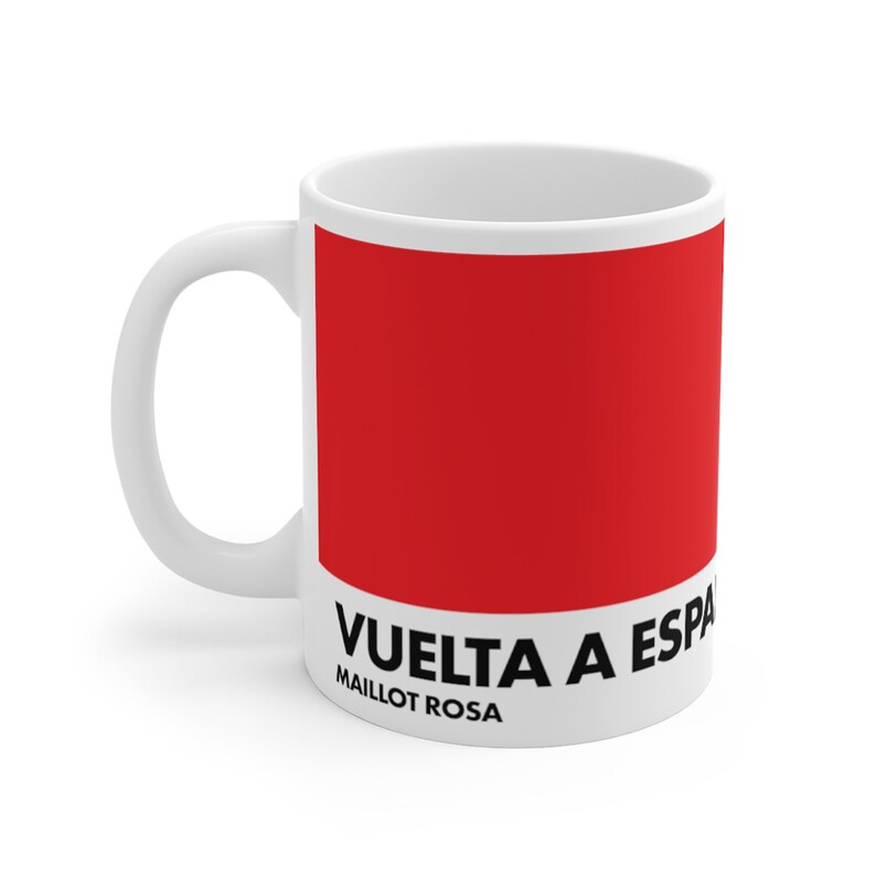May include: White ceramic mug with a red design. The design features the text "VUELTA A ESPA&Ntilde;A" and "MAILLOT ROSA".