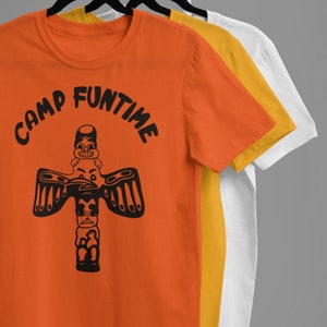 May include: Orange, yellow, and white t-shirts with a black graphic of a totem pole with the text "Camp Funtime" on the orange shirt.