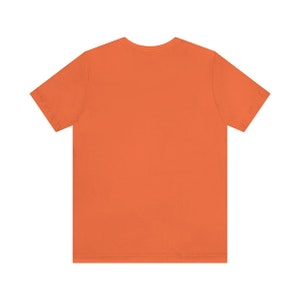 May include: A plain orange short-sleeved t-shirt.