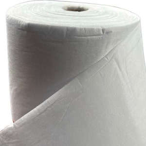 May include: A white roll of non-woven fabric, a type of material often used for crafts and DIY projects.