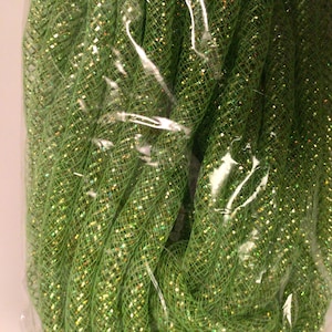 May include: A bundle of green mesh tubing with sparkling gold flecks, tightly coiled and contained within a clear plastic bag. The mesh has a woven pattern, and the gold flecks add a festive, glittery appearance. Ideal for crafting and decorative projects.
