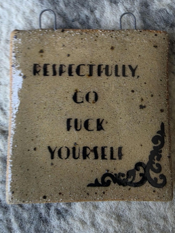 Handmade ceramic hanging sign with a delightfully rude send-off — the craftsmanship elevates it from novelty to actual wall art.