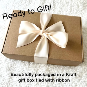 May include: A Kraft gift box tied with a cream-colored ribbon. The box is rectangular and has the text "Ready to Gift!" in black script. The bottom of the box has the text "Beautifully packaged in a Kraft gift box tied with ribbon."
