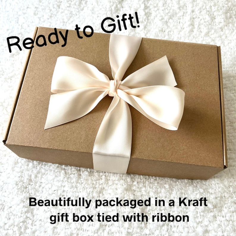 May include: A Kraft gift box tied with a cream-colored ribbon. The box is rectangular and has the text "Ready to Gift!" in black script. The bottom of the box has the text "Beautifully packaged in a Kraft gift box tied with ribbon."