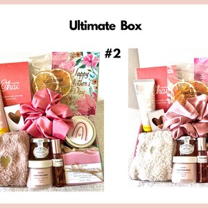 May include: Two gift boxes filled with various items, including bath products, a hair scrunchie, a small towel, and a card that says "Happy Mother's Day".