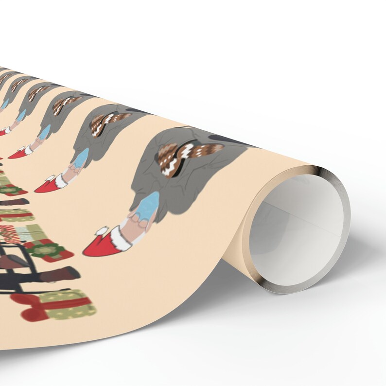 May include: Beige wrapping paper with a repeating pattern of a gnome wearing a grey coat and blue shoes, holding a brown and white cookie. The gnome is wearing a red Santa hat. The wrapping paper also features a green garland with red and white baubles.