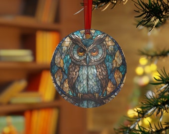 May include: A round Christmas ornament featuring a stained glass owl with blue, brown, and yellow colors. The owl is perched on a branch with its wings spread.