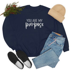 Peut inclure: Un sweat-shirt bleu marine avec le texte "You are my purpose" en lettres blanches.