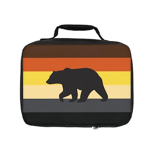 May include: Black lunch bag with a brown, orange, yellow, and gray striped design featuring a silhouette of a bear.