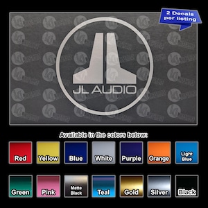 May include: A vinyl decal featuring the JL Audio logo enclosed in a circle, with the text 2 Decals per listing. Below, a color chart displays fourteen available options: red, yellow, blue, white, purple, orange, light blue, green, pink, matte black, teal, gold, silver, and black.