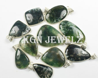 May include: A collection of green and white moss agate pendants in various shapes, including teardrop, oval, and square. Each pendant has a silver-colored bail for attaching to a chain. The text "KGN JEWELZ" is visible.