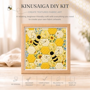 May include: A Kinusaiga DIY kit featuring a square wooden frame containing a textured fabric art piece. The artwork displays a yellow honeycomb pattern with sunflowers, small blue flowers, and two bees with black and yellow striped bodies.