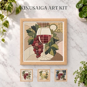 May include: A Kinusaiga art kit featuring a framed square fabric collage of a wine glass filled with red wine and a cluster of grapes. The design uses various plaid and textured fabric patterns in shades of red, green, and beige. Three smaller versions of the art kit are displayed below the main framed piece.